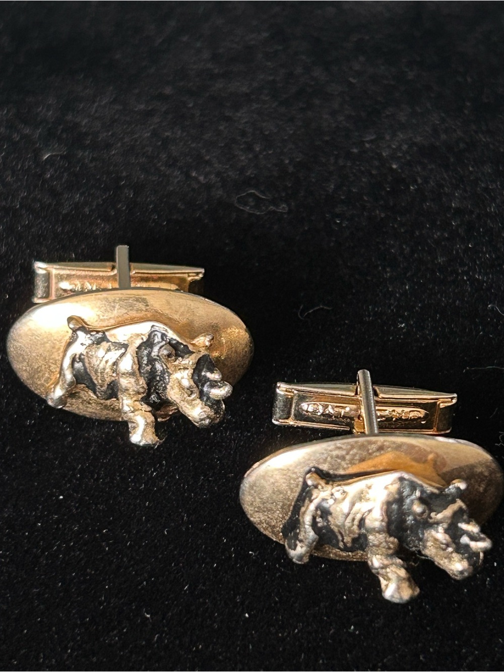 Rhinoceros gold tone cufflinks embossed with Armstrong Tires on the underneath.